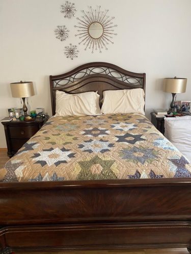 A hexagon quilt on a dark wood bed